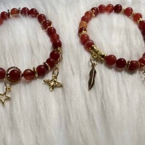 Good Fortune Bracelet featuring red gemstone beads, gold accents, and symbolic charms for luck and protection